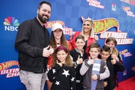 Travis Mullen and Gina Kirschenheiter with their children on red capet for "Hot Wheels: Ultimate Challenge"