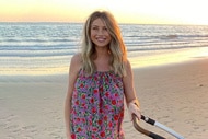 Ashley Jacobs wearing a colorful dress at the beach