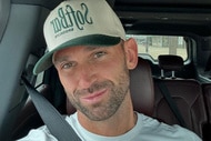 Carl Radke posing in a car with a hat on.