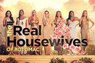 The cast of The Real Housewives of Potomac standing in front of cherry blossom trees for their tagline video