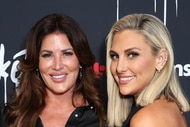 Emily Simpson and Gina Kirschenheiter smiling in front of a step and repeat.