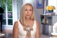 Sutton Stracke wearing a white dress with a gold bedazzled cross on the chest.