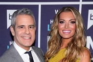 Andy Cohen and Lindsay Hubbard pose together in front of a step and repeat.