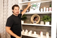 Craig Conover at his store Sewing Down South in front of a wall display