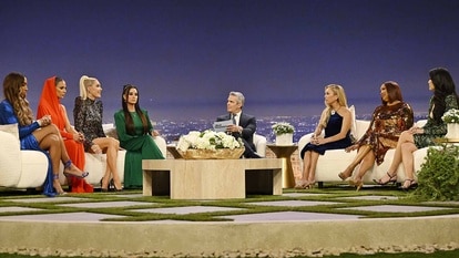 The cast of The Real Housewives of Beverly Hills listen to Andy Cohen in front of a Beverly Hills themed set during the Season 13 Reunion.