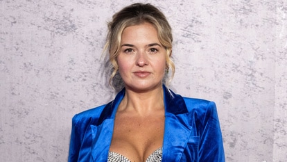 Daisy Kelliher wearing a blue blazer and a sequin silver bra at the Napoleon premiere