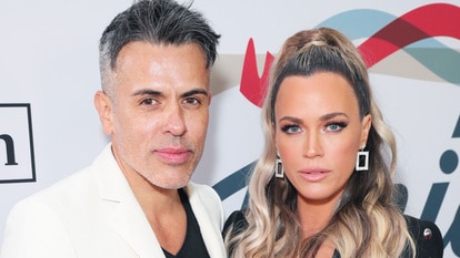 Teddi Mellencamp and Edwin Arroyave posing in front of a step and repeat.