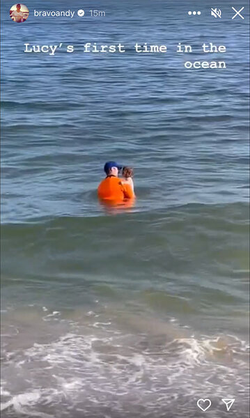 Andy holding Lucy while in the ocean.