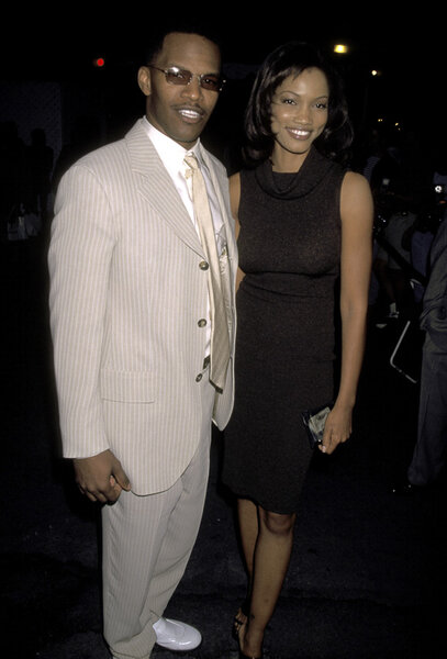 Young Garcelle posing with Eddie in cocktail attire.