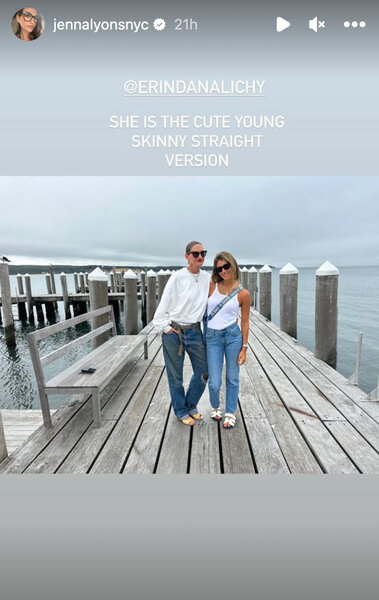 Jenna Lyons and Erin Lichy wear white tops and blue denim pants while on a boardwalk on the ocean.