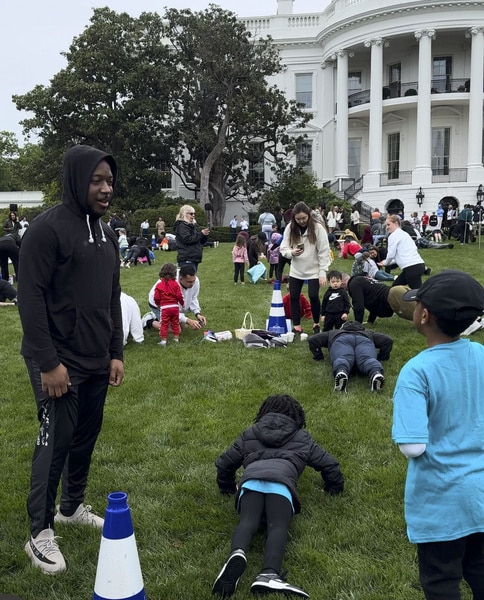 The White House lawn with guests walking on it.