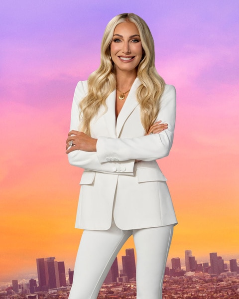 Heather Altman wearing a white blazer in front of a purple and pink sky and LA cityscape