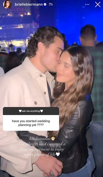 Billy Seidl kisses fiancé Brielle Biermann on the cheek while on a boat.