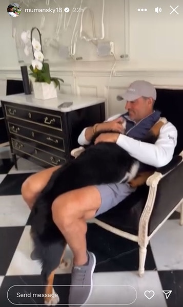 Mauricio Umansky sitting and holding one of his dogs.