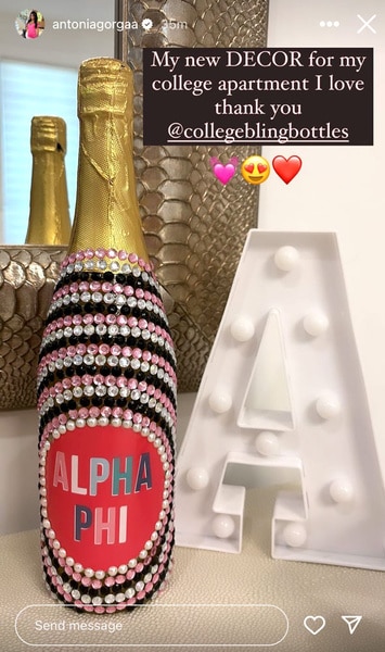 A bottle that looks like champagne but has Alpha Phi written on it.