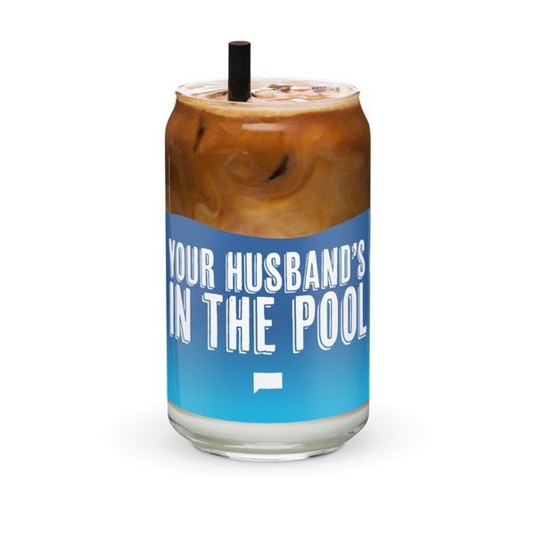 A glass full of coffee that says, "you're husband is in the pool"