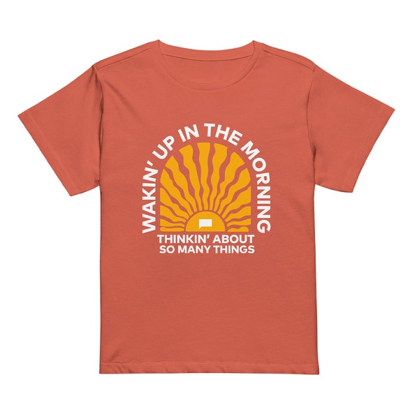 An orange tee that reads "Waking up in the Morning Thinking about so many things"