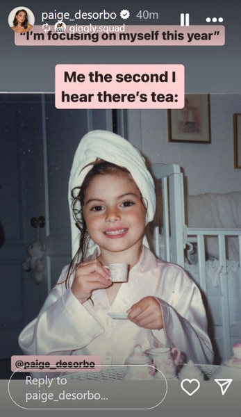 Paige Desorbo as a little girl wearing a robe with a towel around her wet hair and drinking tea.