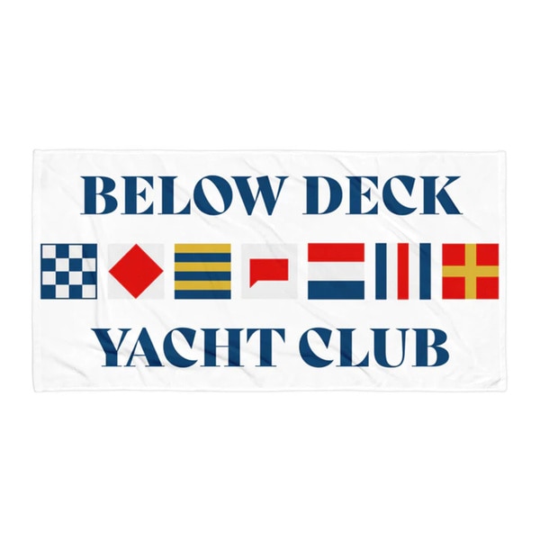 a Beach Towel that has the copy Below Deck Yacht Club on it