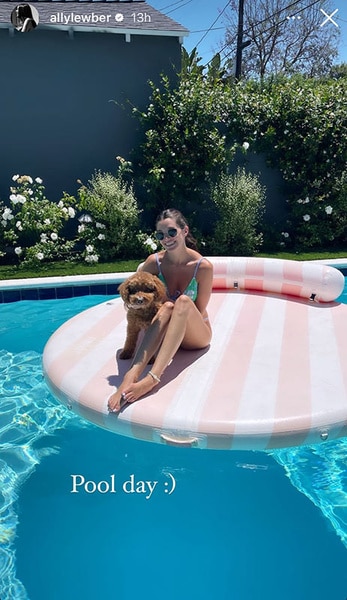 Ally Lewber sitting on a pool floatie with her dog, Hippie.