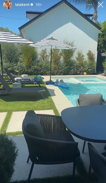 Lala Kent's pool with lounge chairs and seating around it.