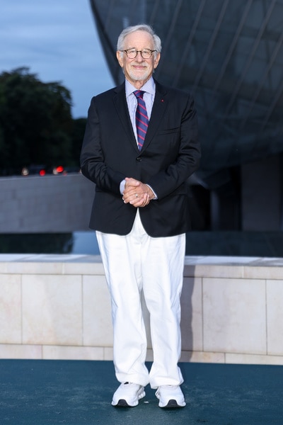 Steven Spielberg wears white pants and a blue jacket to the prelude to the olympics