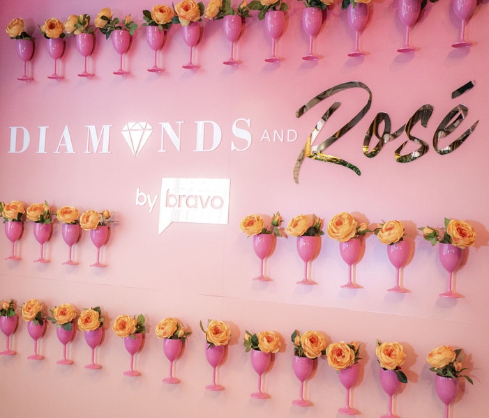 A photo wall at the Bravo Diamonds and Rosé experience.