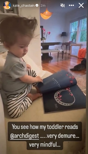 Kate Chastain's son Sullivan reading a magazine