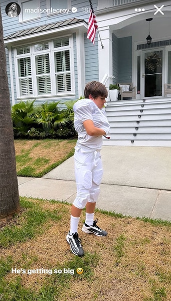 Hudson Hughes standing outside in his football uniform.