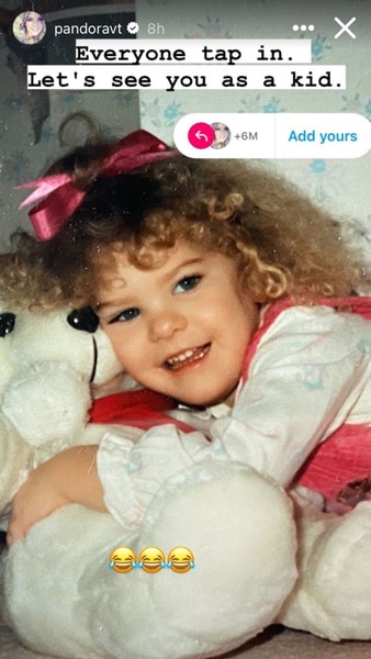 Pandora Vanderpump as a little girl holding a stuffed animal