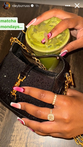 Riley Burruss' holding a purse and cup of matcha with a pink toned manicure.