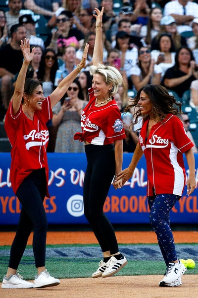 Jennifer Fessler, Dorinda Medley, and Dolores Catania, celebrating at the charity softball game.