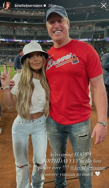 Brielle Biermann Kroy Biermann posing together on a baseball field.