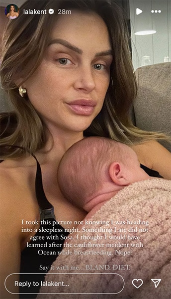 Lala Kent holding Sosa Kent while sitting.