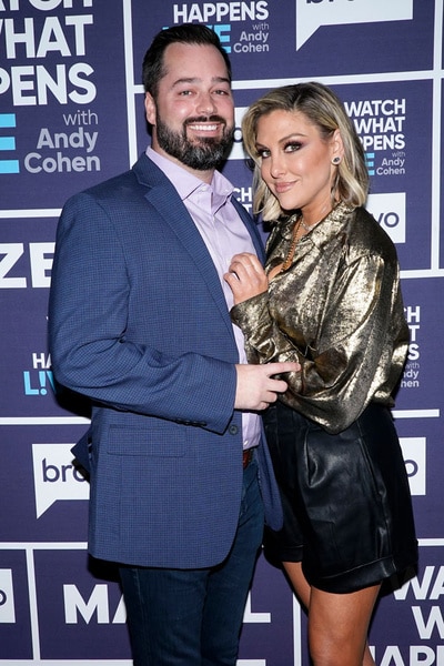 Travis Mullen and Gina Kirschenheiter in front of the WWHL step and repeat