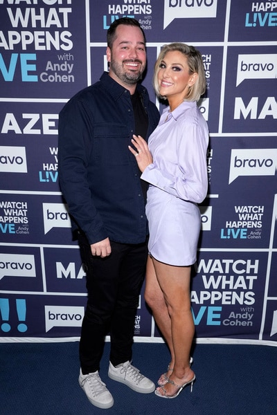 Travis Mullen and Gina Kirschenheiter in front of the Watch What Happens step and repeat