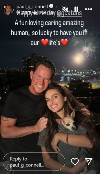 Paul Connell and Gabby Catania together on a balcony while Gabby holds a dog