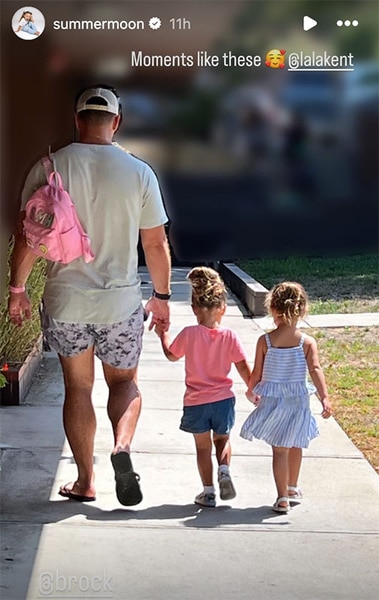 Brock Davies walking Summer Moon Davies and Ocean Emmett Kent to school.