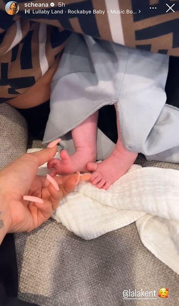 Scheana Shay holding baby Sosa Kent's foot.