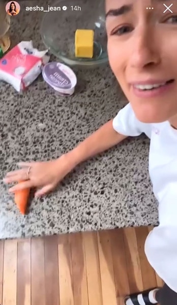 Aesha Scott sitting at a counter with a carrot in her hand