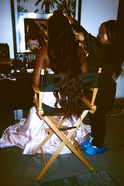 Bozoma Saint John getting her hair done in front of a mirror at the RHOBH Season 14 press shoot