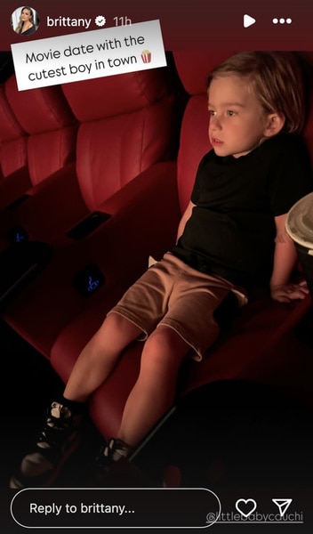 Cruz Cauchi sitting in a movie theatre.