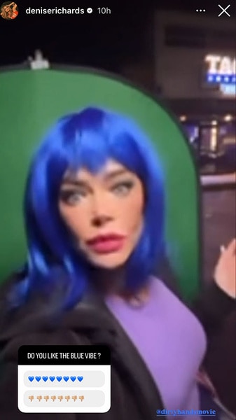 Denise Richards posing in a blue wig.