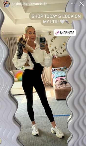 Heather Altman posing in the mirror with her dog.