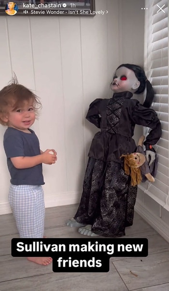 Sullivan Chastain standing next to a Halloween figurine.