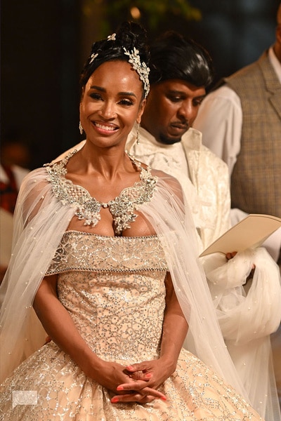 Dr. Contessa Metcalfe wearing a white and silver gown with a cape on her