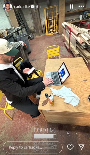 Carl Radke sitting in a construction zone and working on his laptop