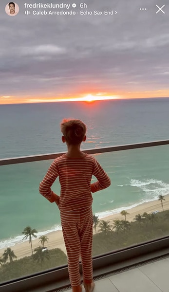 Fredrik Eklund Jr watching the sunset from a balcony.