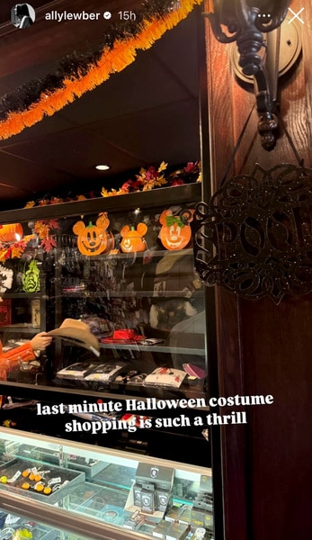 the display case at a store with Halloween costumes and decorations in it.