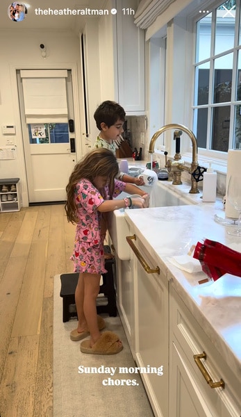 Lexi and Ace Altman washing dishes together in the kitchen.